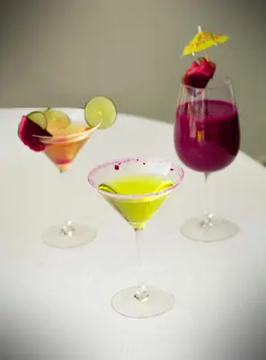 three cocktails sitting on a white table at Hotel Dominican Barcelona in SJM
