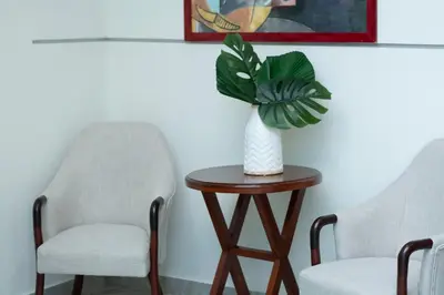 two chairs and a vase on a table with a plant at Hotel Dominican Barcelona in SJM
