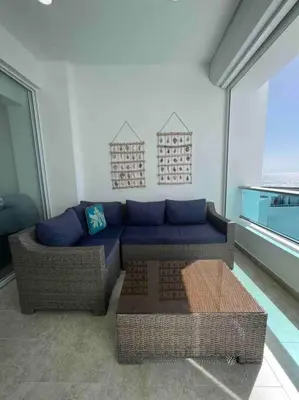 a living room with a couch and a table at Bueno Paradise Condo In Marbella in Juan Dolio