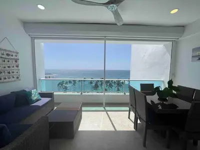 a living room with a view of the ocean at Bueno Paradise Condo In Marbella in Juan Dolio