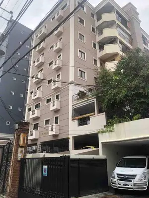a tall building with a car parked in front of it at Modern Centrical Evaristo Apartment With Tub in Los Prados