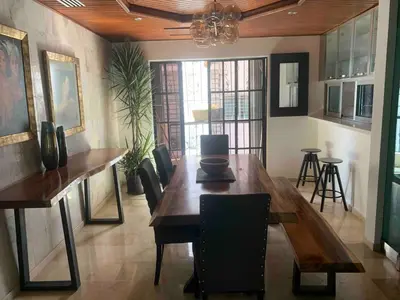 a dining room with a wooden table and chairs at Modern Centrical Evaristo Apartment With Tub in Los Prados