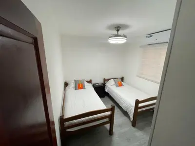 a small room with two beds and a window at Desiderio in Santo Domingo