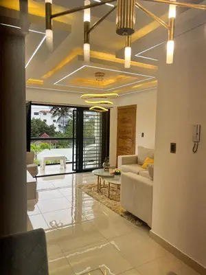 a living room with a couch and a table at Ático fantástico in Santiago de los Caballeros