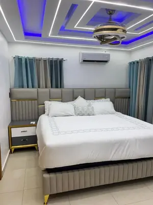 a bedroom with a large bed with a blue ceiling at Ático fantástico in Santiago de los Caballeros