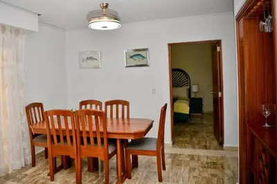 a dining room with a wooden table and chairs at Punta Cana 1-Bed Apt Sleeps 4 with Pool & Hot Tub in Punta Cana