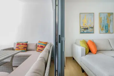 a living room with two couches and a table at Beauty condo pool views with gym close to the beach in Punta Cana