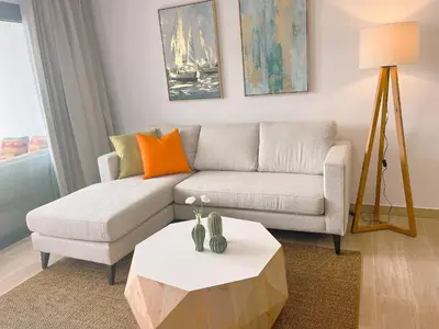 a living room with a couch and a table at Beauty condo pool views with gym close to the beach in Punta Cana