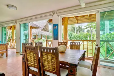 a dining room with a wooden table and chairs at Serene Beach Haven In Las Terrenas in Las Terrenas