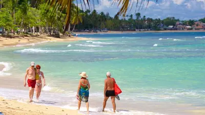 a group of people walking on the beach at Serene Beach Haven In Las Terrenas in Las Terrenas