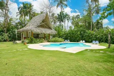 a resort with a swimming pool and a hut at Serene Beach Haven In Las Terrenas in Las Terrenas