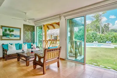 a living room with a couch and a table at Serene Beach Haven In Las Terrenas in Las Terrenas
