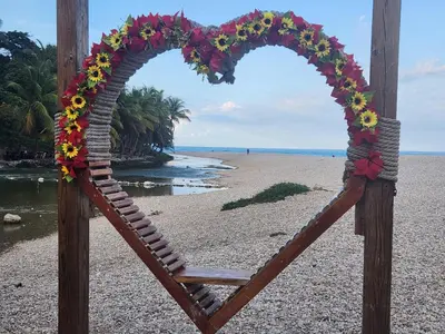 a wooden frame with a heart shapedreath on a beach at Penthouse Apartment with Bay and Mountain Views, Rooftop BBQ, AC, Fast WiFi, Near Saladilla Beach, Barahona in Santa Cruz de Barahona