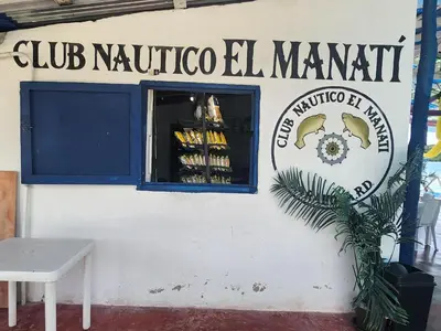 a sign on a building that reads club nautico el manoit at Penthouse Apartment with Bay and Mountain Views, Rooftop BBQ, AC, Fast WiFi, Near Saladilla Beach, Barahona in Santa Cruz de Barahona