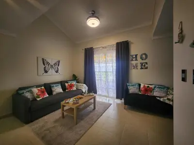 a living room with a couch and a coffee table at Penthouse Apartment with Bay and Mountain Views, Rooftop BBQ, AC, Fast WiFi, Near Saladilla Beach, Barahona in Santa Cruz de Barahona