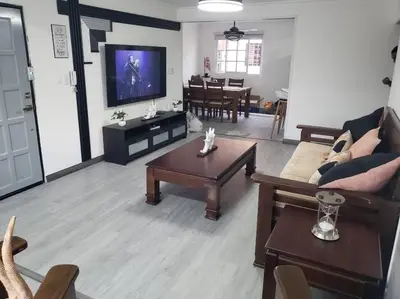 a living room with a couch and a table at Los Robles in Santo Domingo