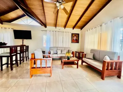 a living room with couches and a dining room at Encantadora Terraza de Brisas Frescas in Jarabacoa