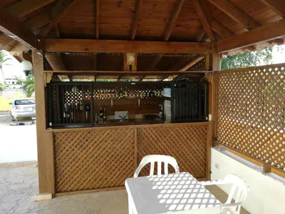 an outdoor bar with a table and chairs at Tropical Caribe in Bayahibe
