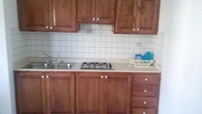 a kitchen with wooden cabinets and a sink at Tropical Caribe in Bayahibe