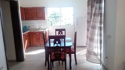 a kitchen with a table and chairs and a refrigerator at Tropical Caribe in Bayahibe