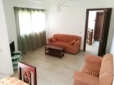 a living room with a couch and a table at Tropical Caribe in Bayahibe