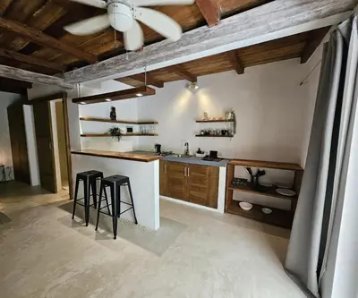 a kitchen with a counter and stools and a ceiling at Soul Dream Bonita in Las Terrenas