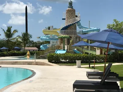 a resort with a pool and a water slide at Apartment in Cadaques Caribe in Bayahibe