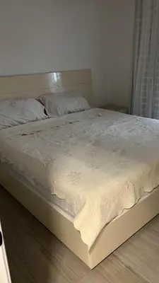 a bed in a bedroom with a white blanket on it at Apartment in Cadaques Caribe in Bayahibe