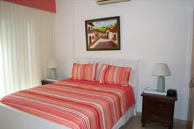a bedroom with a bed and a picture on the wall at Apartment in Cadaques Caribe in Bayahibe