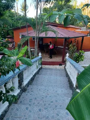 a walkway leading to the front of a house at villa mariposa in Santo Domingo