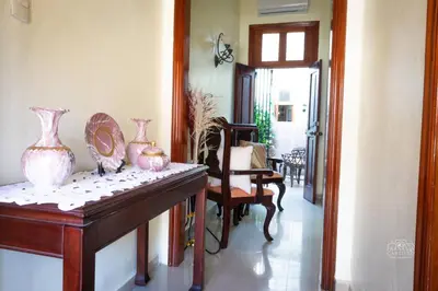 a hallway with a table with vases on it at Charming Colonial Santo Domingo in Santo Domingo