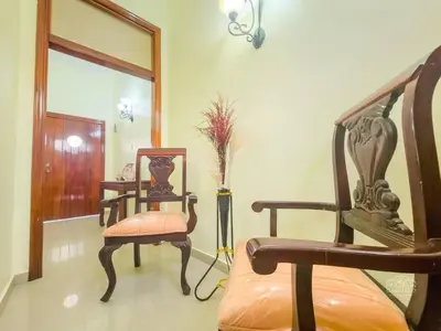a living room with a chair and a mirror at Charming Colonial Santo Domingo in Santo Domingo