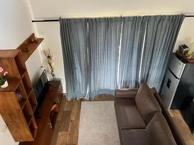 a living room with a couch and a window at Villa Tierrita in Santa Bárbara de Samaná