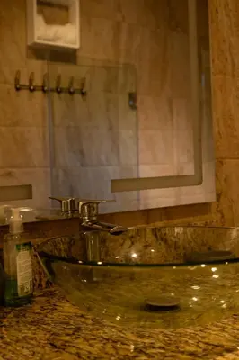 a bathroom with a glass sink and a mirror at Villa Tierrita in Santa Bárbara de Samaná