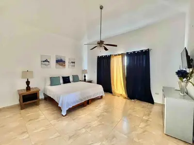 a bedroom with a bed and a ceiling fan at Exclusive Paradise Palms Villa in Sosúa