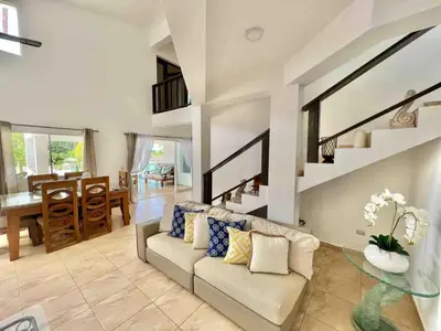 a living room with a couch and a table at Exclusive Paradise Palms Villa in Sosúa
