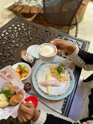 a person sitting at a table with a plate of food at Empyrean Art Deco in Santo Domingo