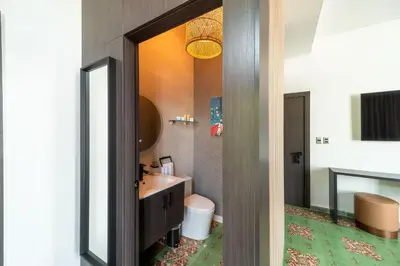 a bathroom with a sink and a toilet and a mirror at Empyrean Art Deco in Santo Domingo