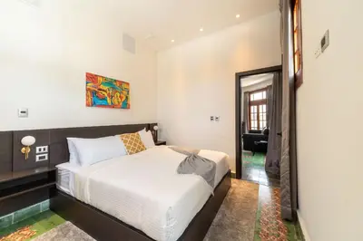 a bedroom with a large white bed in it at Empyrean Art Deco in Santo Domingo