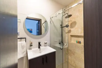 a bathroom with a sink and a shower at Empyrean Art Deco in Santo Domingo