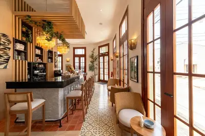 a bar in a restaurant with chairs and tables at Empyrean Art Deco in Santo Domingo