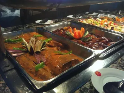 a buffet with two trays of food on a table at Celuisma Playa Dorada All Inclusive in Sampiño
