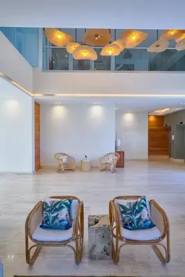 two chairs in a large room with a room with at Aquarella Sunset Caribbean Beachfront Gataway in La Puntica de Juan Dolio