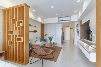 a living room with a couch a table and a tv at Aquarella Sunset Caribbean Beachfront Gataway in La Puntica de Juan Dolio