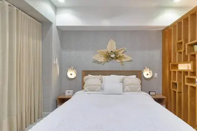 a bedroom with a large white bed in a room at Aquarella Sunset Caribbean Beachfront Gataway in La Puntica de Juan Dolio