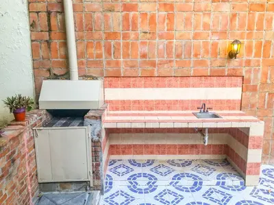 a brick wall with a sink on a tiled floor at Villa Infinito Bani's Exclusive Beachside Mansion in Baní