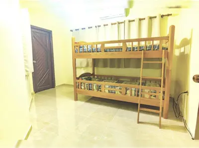 a room with two bunk beds in a room at Villa Infinito Bani's Exclusive Beachside Mansion in Baní