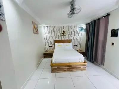 a small bedroom with a bed in a room at Hotel1325 in Baní
