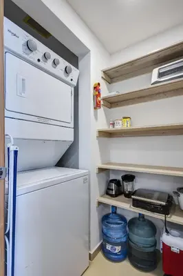 a small kitchen with a refrigerator and a stove at Huge Lux 3br Beachfront Condo Wifi Fast in Paraíso