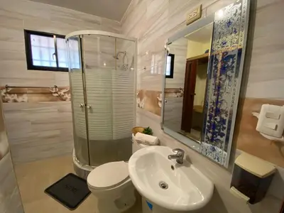 a bathroom with a sink and a toilet and a mirror at Increible Casa Con Piscina! in Los Frailes